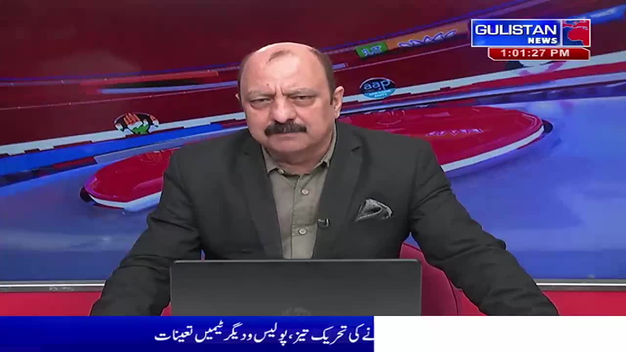 A man with a mustache sits at a desk, looking directly ahead. Behind him, a news graphic displays the Gulistan News logo and the time, 1:01:27 PM.
