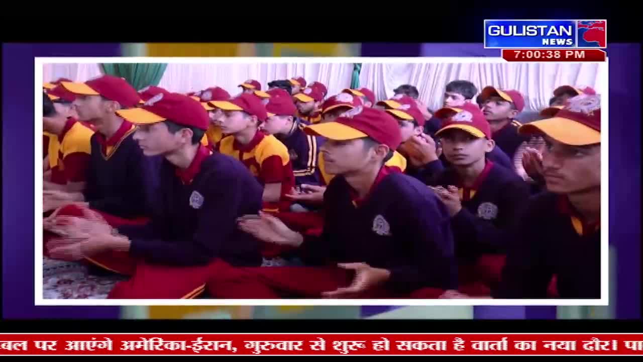 A group of boys in matching maroon and yellow uniforms sit attentively, their faces turned towards something out of frame. The Gulistan News ticker scrolls across the bottom of the screen, indicating this is a broadcast from India.