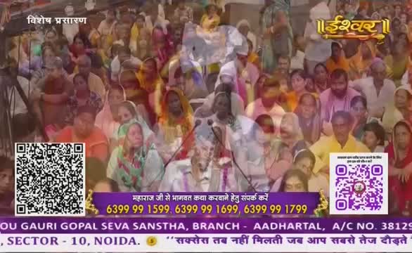 A man speaks into microphones, addressing a large crowd of people, likely at a religious gathering. The broadcast is being shown on Ishwar Bhakti TV, with contact information for a service displayed on the screen.
