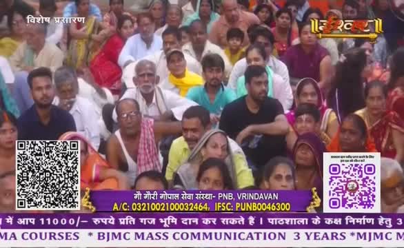 A crowd sits close together, watching something off-camera. The Ishwar Bhakti TV logo is visible, along with a QR code for donations.
