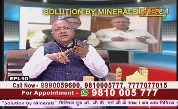 On Ishwar Bhakti TV, a man in a blue vest gestures with his hands, speaking animatedly. Behind him, a screen displays another man in a white shirt.
