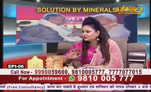A woman in a pink and cream sari gestures with her right hand, speaking on Ishwar Bhakti TV. Behind her, a screen displays a blurred image, and contact information is printed on a lower banner.
