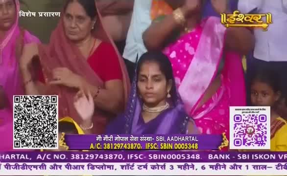 A woman in a purple head covering sits with her hands raised, eyes closed. The scene appears to be a broadcast on Ishwar Bhakti TV, with text promoting a charitable organization in India.
