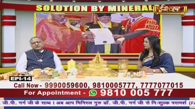 On the Ishwar Bhakti TV set, a man in a vest and a woman in a blue sari sit at a table covered in small, decorative items. A video plays in the background, showing a man in a red robe receiving a document.
On the Ishwar Bhakti TV set, a man in a vest and a woman in a blue sari sit at a table covered in small, decorative items. A video plays in the background, showing a man in a red robe receiving a document.