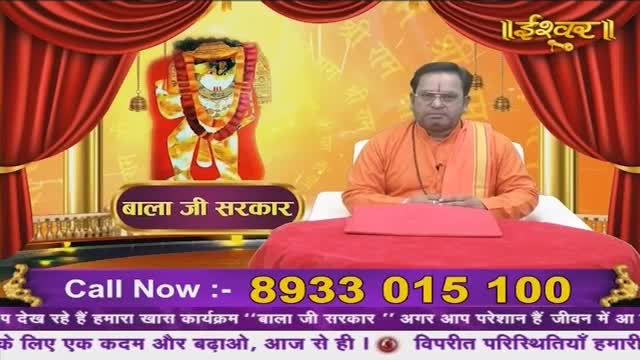 A man in an orange robe sits behind a red table, a portrait of a deity behind him. The Ishwar Bhakti TV logo appears above him.