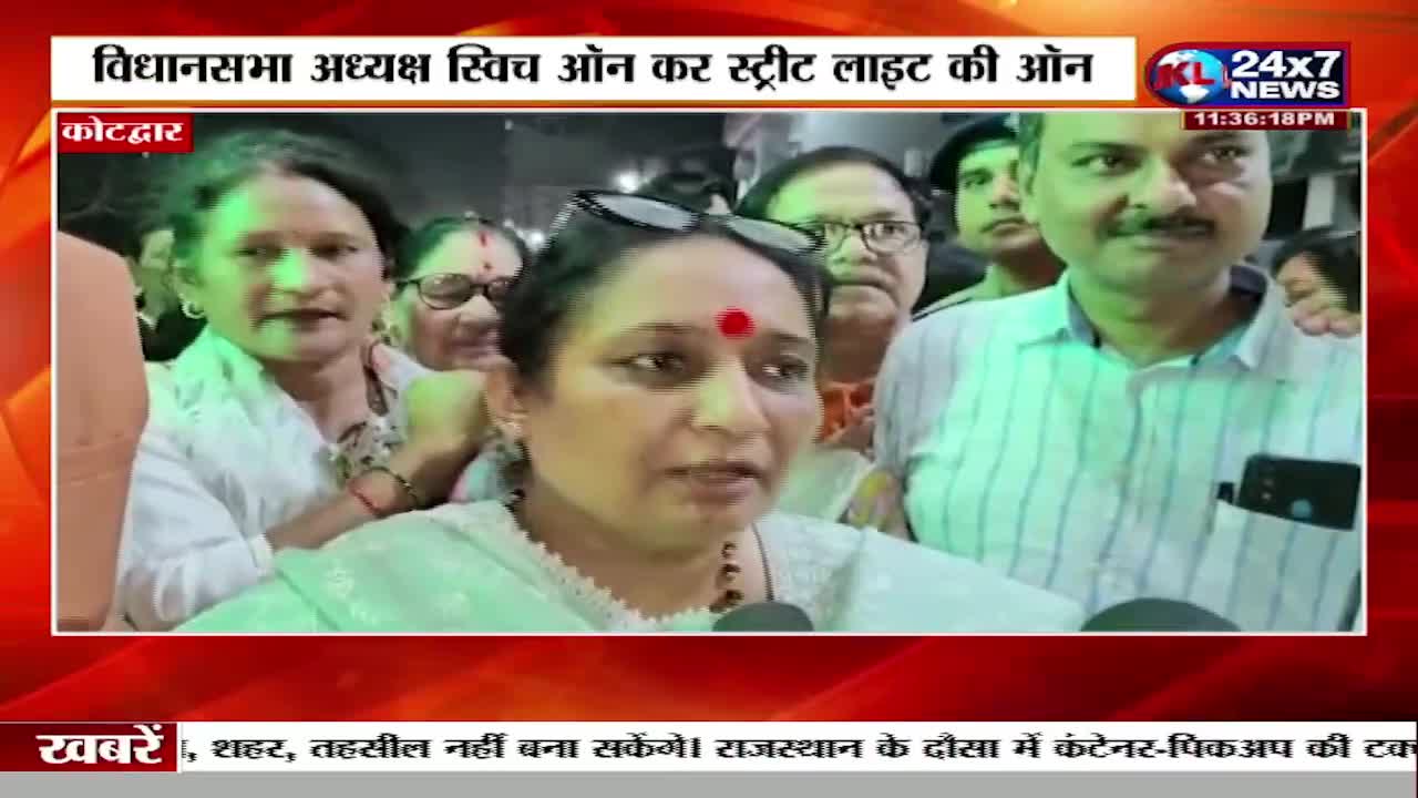A woman with a red bindi speaks into a microphone, surrounded by others who are listening. The JK 24x7 News logo is visible in the corner, indicating that this is likely a news report from India.
