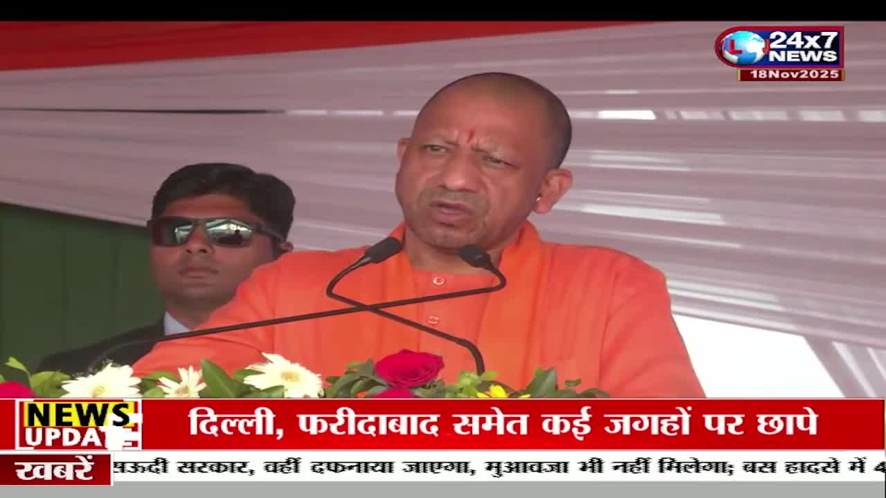 A man in an orange shirt speaks into two microphones, his face animated. The JK 24x7 News logo is visible, and the lower third of the screen displays Hindi text about raids in Delhi and Faridabad.
A man in an orange shirt speaks into two microphones, his face animated. The JK 24x7 News logo is visible, and the lower third of the screen displays Hindi text about raids in Delhi and Faridabad.