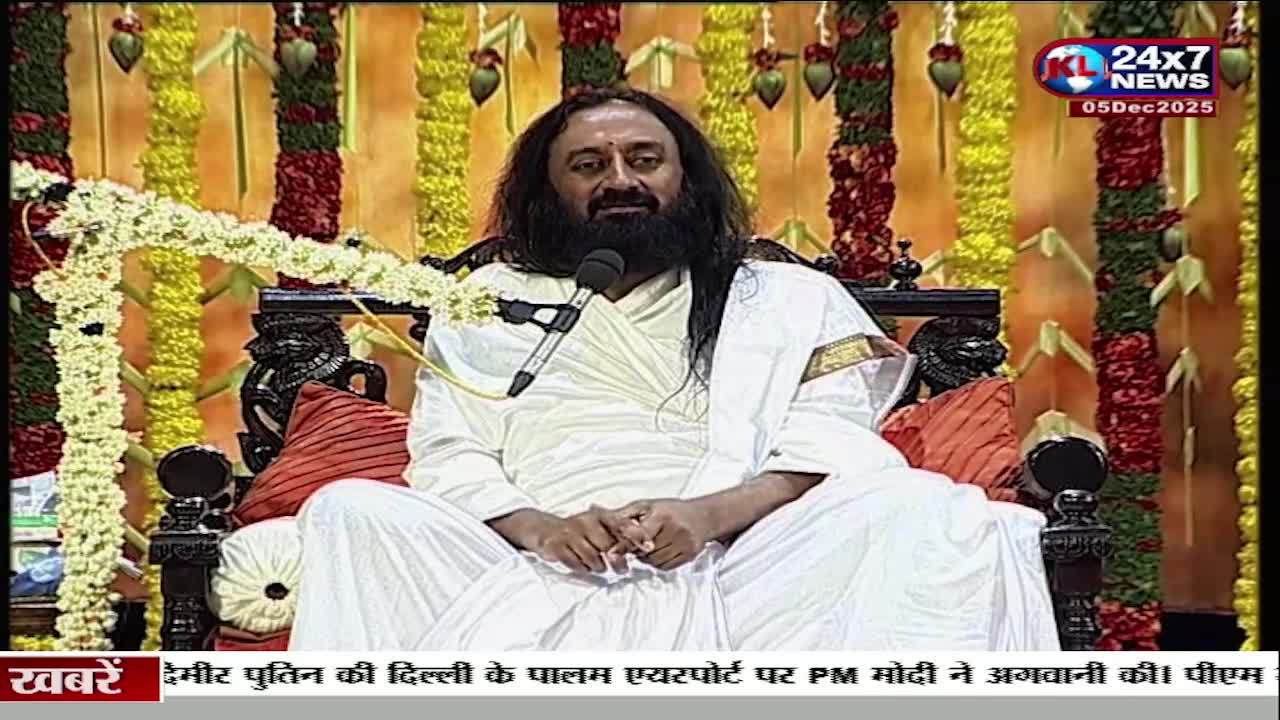 A man with a long beard sits on a carved chair, speaking into a microphone. The JK 24x7 News logo is visible, and the bottom of the screen displays Hindi text about an event in Delhi.
A man with a long beard sits on a carved chair, speaking into a microphone. The JK 24x7 News logo is visible, and the bottom of the screen displays Hindi text about an event in Delhi.