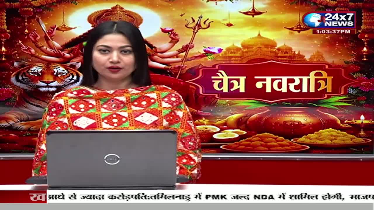 A woman in a vibrant, patterned outfit sits behind a laptop, delivering news. Behind her, a graphic depicts the goddess Durga with multiple arms, a tiger, and offerings of sweets, all set against a backdrop of illuminated temples.