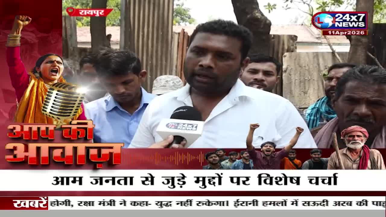 A man speaks into a JK 24x7 News microphone, surrounded by a crowd of people. In the background, a woman with her fist raised shouts passionately. A man speaks into a JK 24x7 News microphone, surrounded by a crowd of people. In the background, a woman with her fist raised shouts passionately.