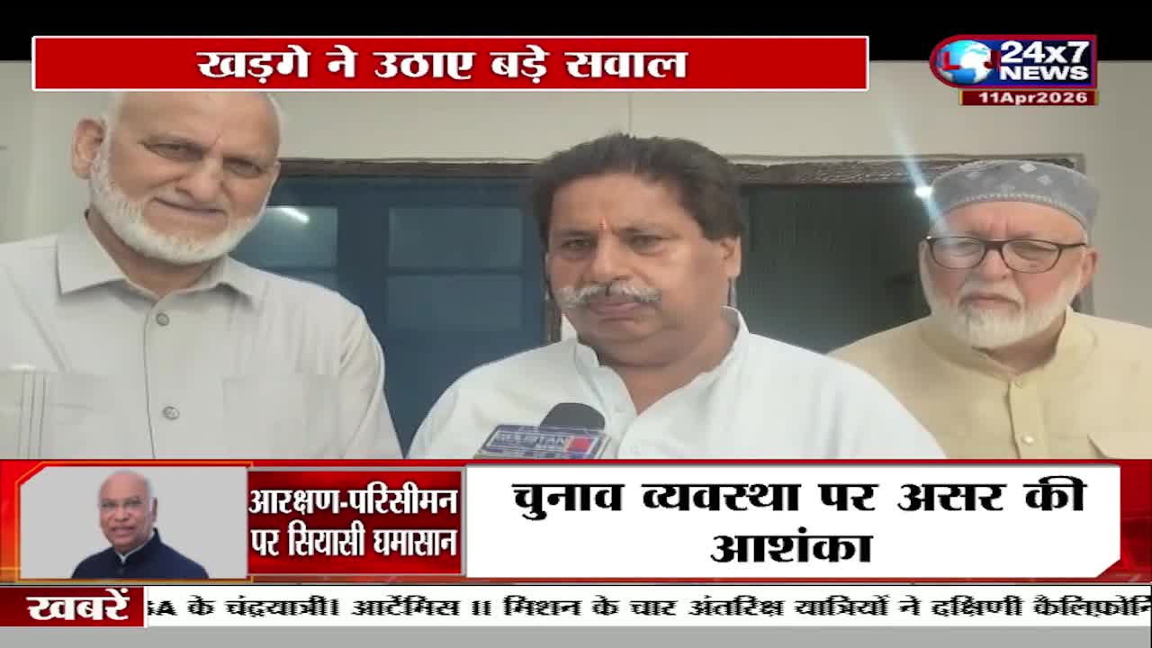 Three men stand in front of a wall, two with beards and one with a mustache. A microphone is held in front of the man with the mustache. A news ticker scrolls at the bottom of the screen. Three men stand in front of a wall, two with beards and one with a mustache. A microphone is held in front of the man with the mustache. A news ticker scrolls at the bottom of the screen.