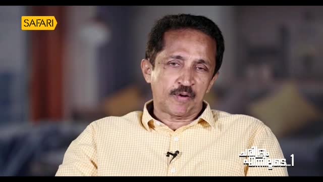 The man in the yellow shirt is speaking, his mouth moving as he looks directly at the camera. A Safari TV logo sits in the corner, and text in Malayalam appears at the bottom right.
