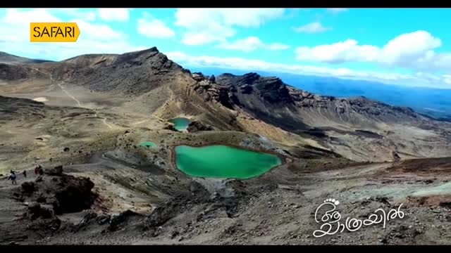 A wide shot reveals a mountainous landscape with three turquoise lakes nestled amongst the peaks. A small group of people are walking along a path, likely on a journey featured on Safari TV.
A wide shot reveals a mountainous landscape with three turquoise lakes nestled amongst the peaks. A small group of people are walking along a path, likely on a journey featured on Safari TV.