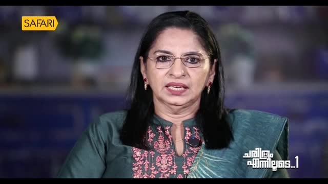 A woman with glasses and dark hair speaks directly into the camera. The Safari TV logo is in the upper left corner, and text in Malayalam appears on the lower right.
A woman with glasses and dark hair speaks directly into the camera. The Safari TV logo is in the upper left corner, and text in Malayalam appears on the lower right.