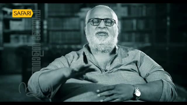 A man with a white beard and glasses gestures with his hands, speaking on camera for Safari TV. The backdrop is a blurred bookshelf, and the logo is visible in the corner.
A man with a white beard and glasses gestures with his hands, speaking on camera for Safari TV. The backdrop is a blurred bookshelf, and the logo is visible in the corner.