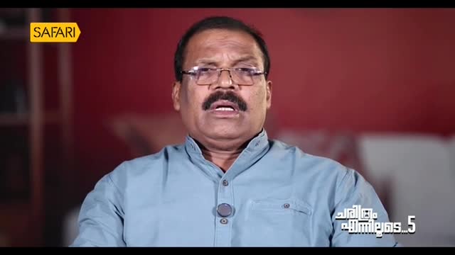 The man in the light blue shirt is speaking, his mouth open as he looks directly at the camera. A "Safari" logo is in the top left corner, and the show's title is visible on the right.
