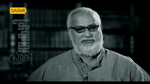 A man with a white beard and glasses looks directly at the camera, likely in an interview for Safari TV. The show's logo is in the upper left corner, and the title is written in Malayalam.
A man with a white beard and glasses looks directly at the camera, likely in an interview for Safari TV. The show's logo is in the upper left corner, and the title is written in Malayalam.
