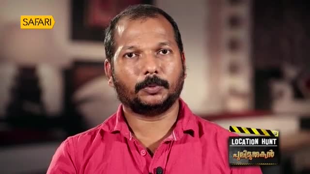 A man with a beard and mustache, wearing a bright pink shirt, speaks directly to the camera. A graphic overlay in the corner identifies the program as "Location Hunt" on Safari TV. A man with a beard and mustache, wearing a bright pink shirt, speaks directly to the camera. A graphic overlay in the corner identifies the program as "Location Hunt" on Safari TV.