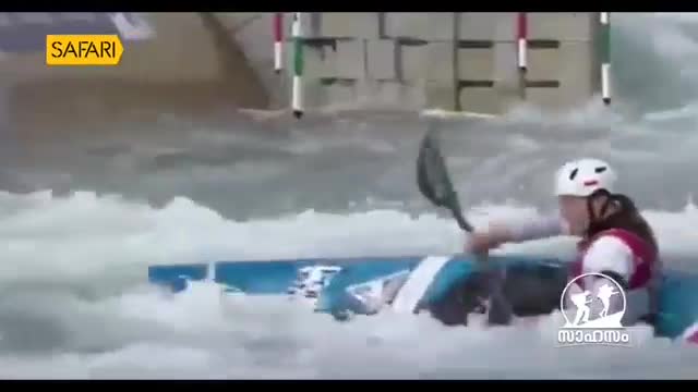 A kayaker in a white helmet navigates rough water, paddling hard. The "Safari" logo appears in the upper left corner, and a Malayalam word, "സാഹസം" (Sahasam), meaning adventure, is visible in the lower right.