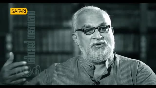 The man with a white beard and glasses speaks passionately, his hand gesturing. A yellow "Safari" logo sits above Malayalam text on the left.