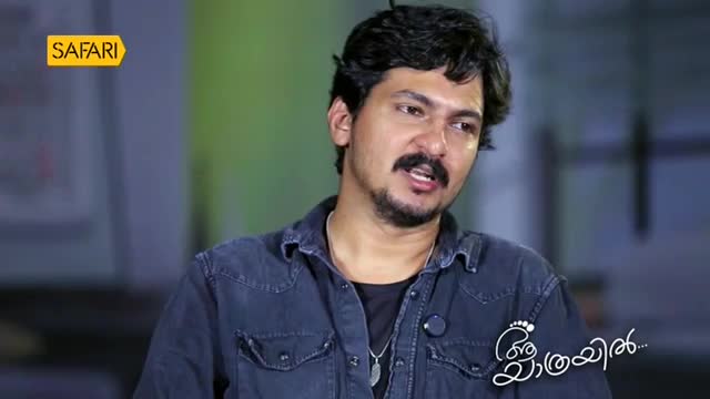 A man with a mustache and beard, wearing a denim shirt, speaks directly to the camera. The Safari TV logo is visible in the upper left corner.