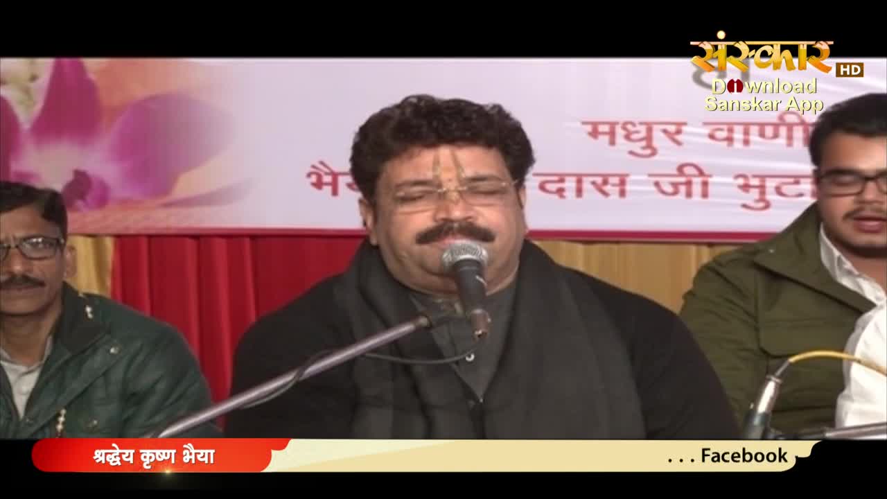A man with a thick mustache sings into a microphone, his eyes closed. He's wearing glasses and a black scarf, and the Sanskar TV logo is visible in the top right corner.
