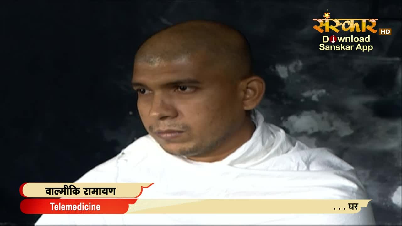 A man with a shaved head and a white garment looks directly ahead, his expression serious. The Sanskar TV logo and text about "Telemedicine" appear at the bottom of the screen.
