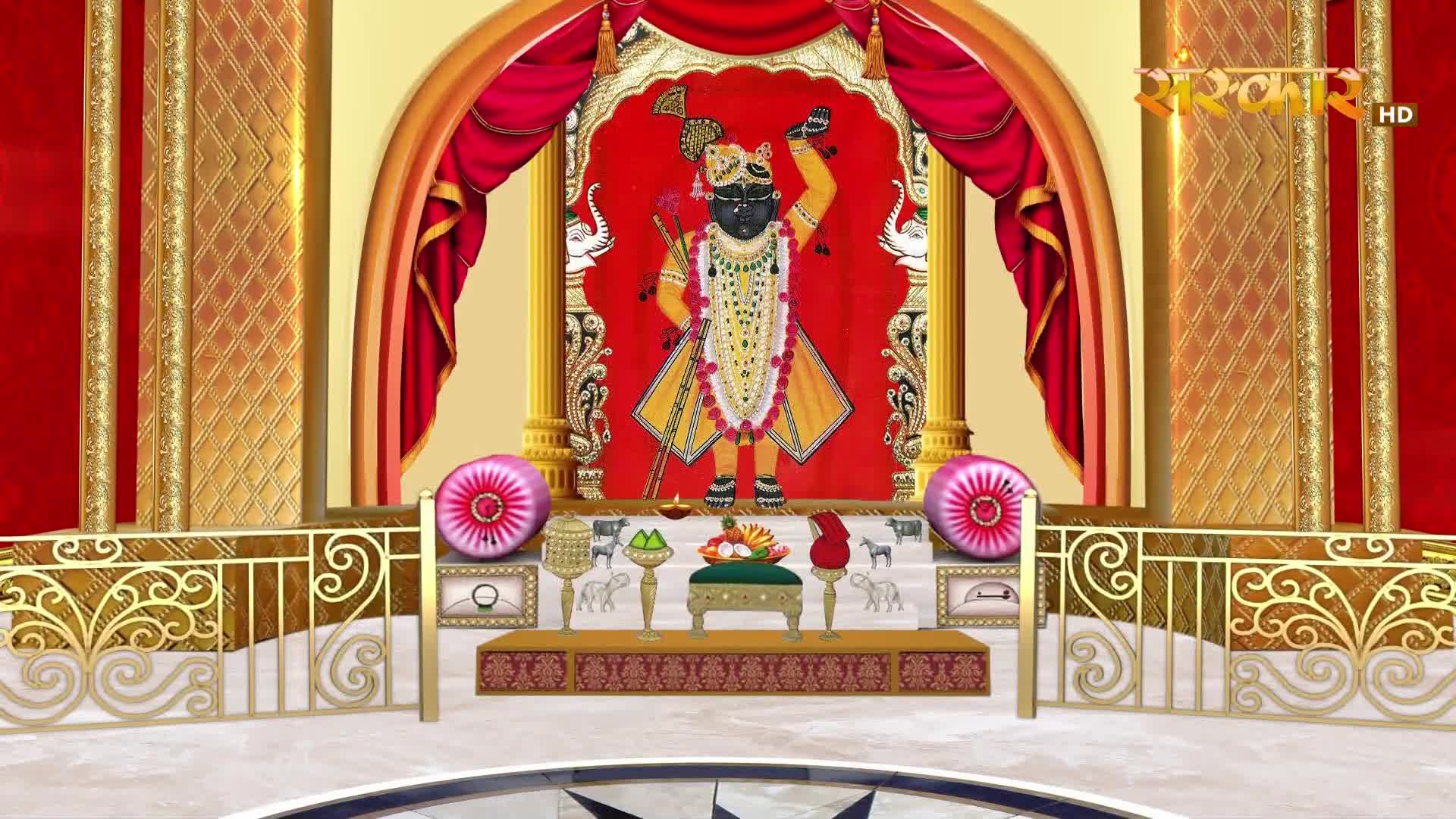 A divine figure stands on a raised platform, adorned in yellow and white. The Sanskar TV logo is visible in the upper right corner.