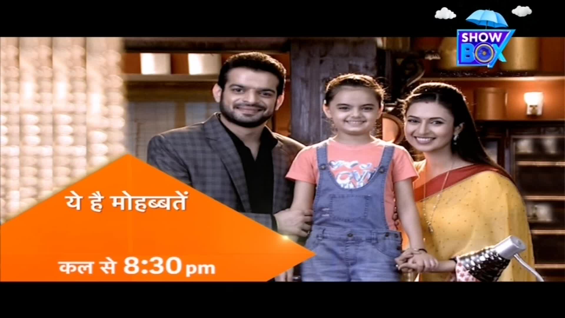A smiling family of three, the parents flanking a young girl, pose for a promo image. An orange banner with Hindi text and time information for "Yeh Hai Mohabbatein" from ShowBox fills the foreground.
