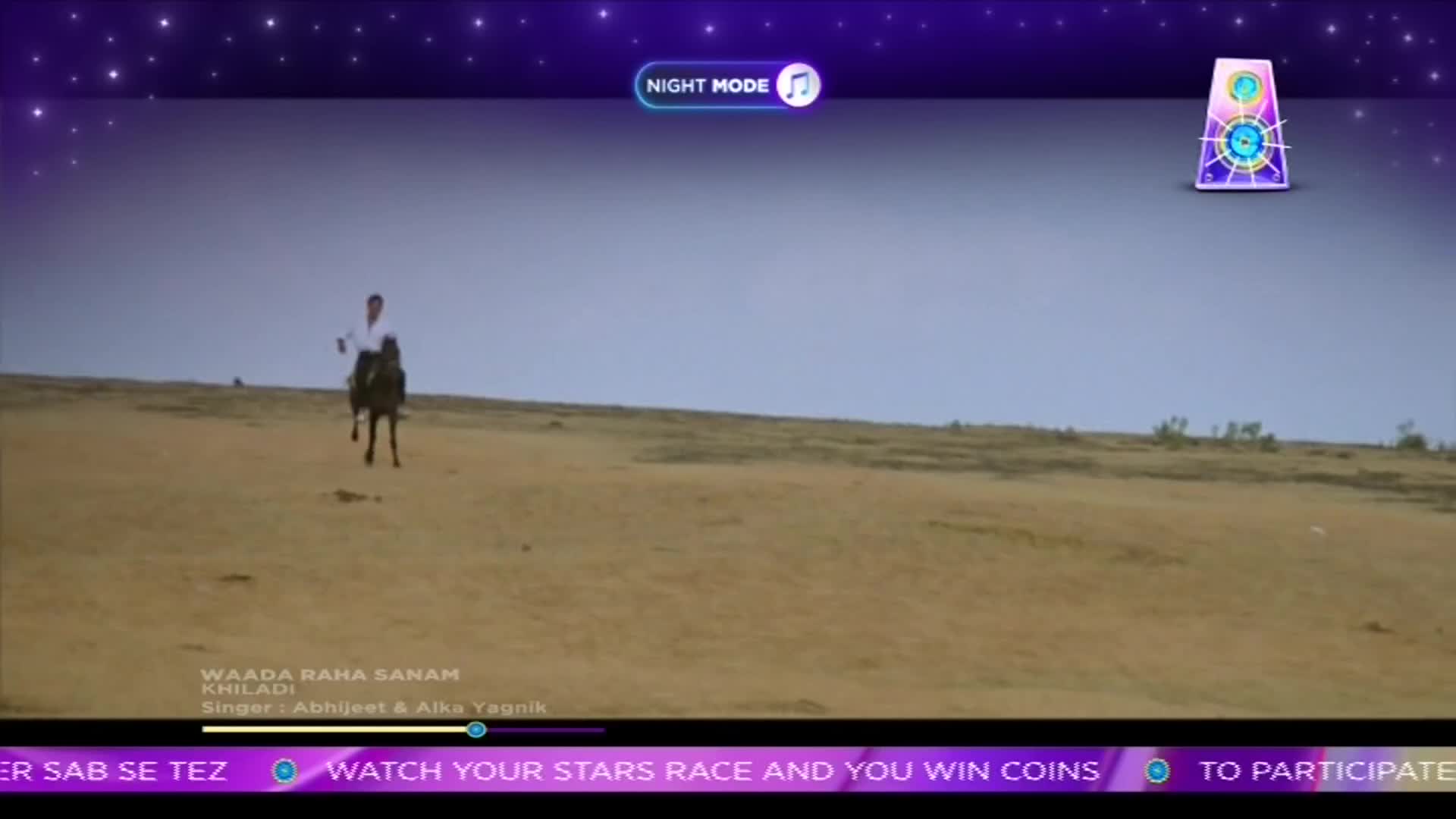 A man on horseback rides across a barren landscape, the horse's dark coat contrasting with the pale earth. The scene is presented on a ShowBox screen, the song "Waada Raha Sanam" playing in the background.
