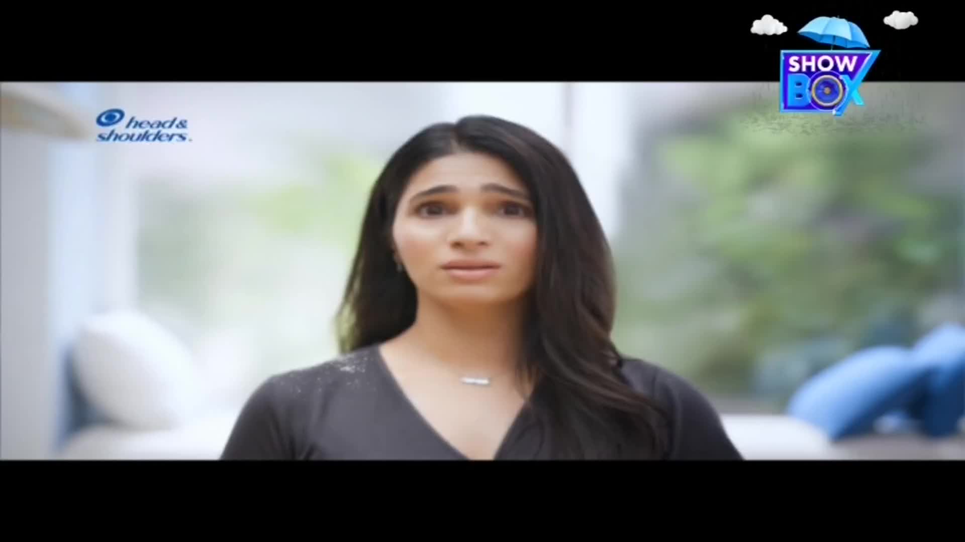 A woman with long black hair stares forward, her expression concerned. Flakes are visible on her shoulder, and a "Head & Shoulders" logo is in the corner, suggesting a commercial on ShowBox from India.
