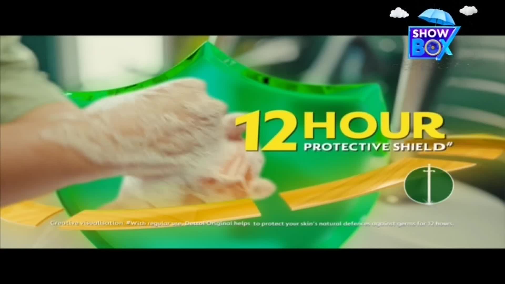 A hand, covered in suds, is positioned in front of a green shield graphic. The words "12 HOUR PROTECTIVE SHIELD" are displayed prominently, with the ShowBox logo in the corner.
