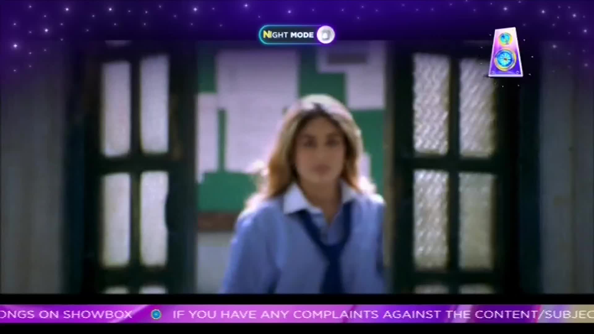 A woman in a school uniform stands in a doorway, looking directly ahead. The scene, framed by a ShowBox interface, appears to be a still from a film.
