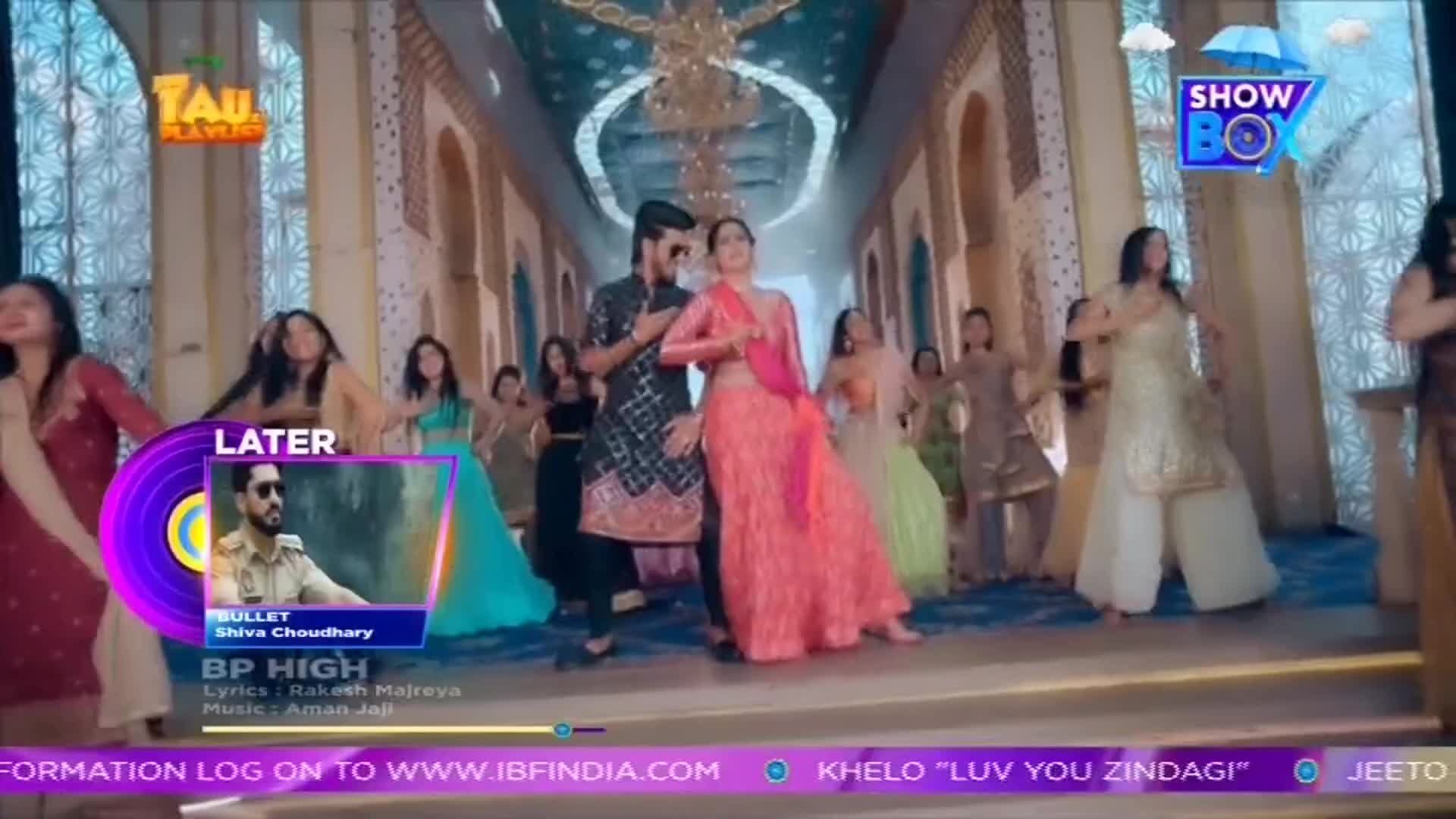 A couple in traditional Indian clothing dance in the center of a large room, surrounded by a group of women. The ShowBox logo is in the corner, and a "Later" graphic previews a music video by Shiva Choudhary.
