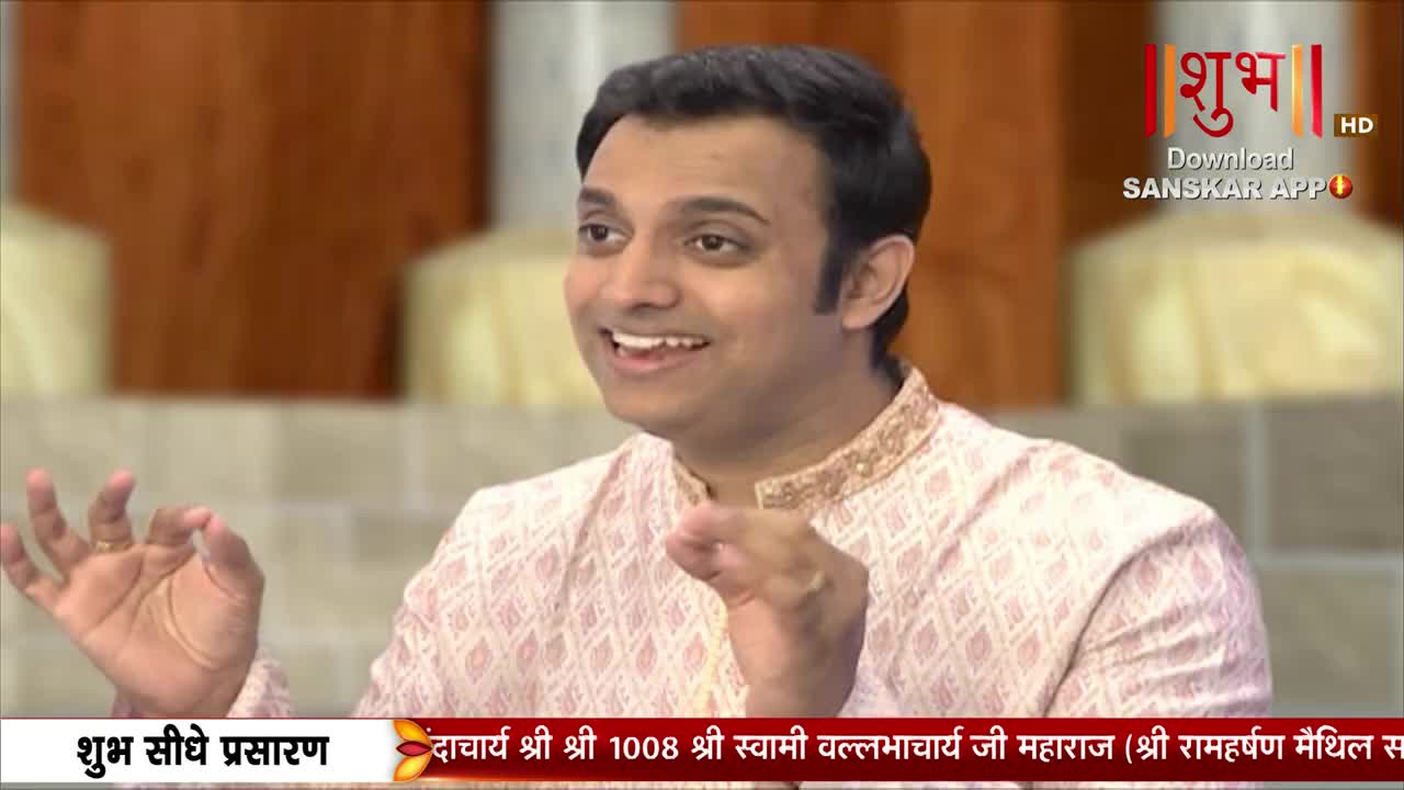 The man in the patterned shirt gestures with his hands, smiling broadly as he speaks. The Shubh TV logo is visible in the corner, with text scrolling along the bottom of the screen.
