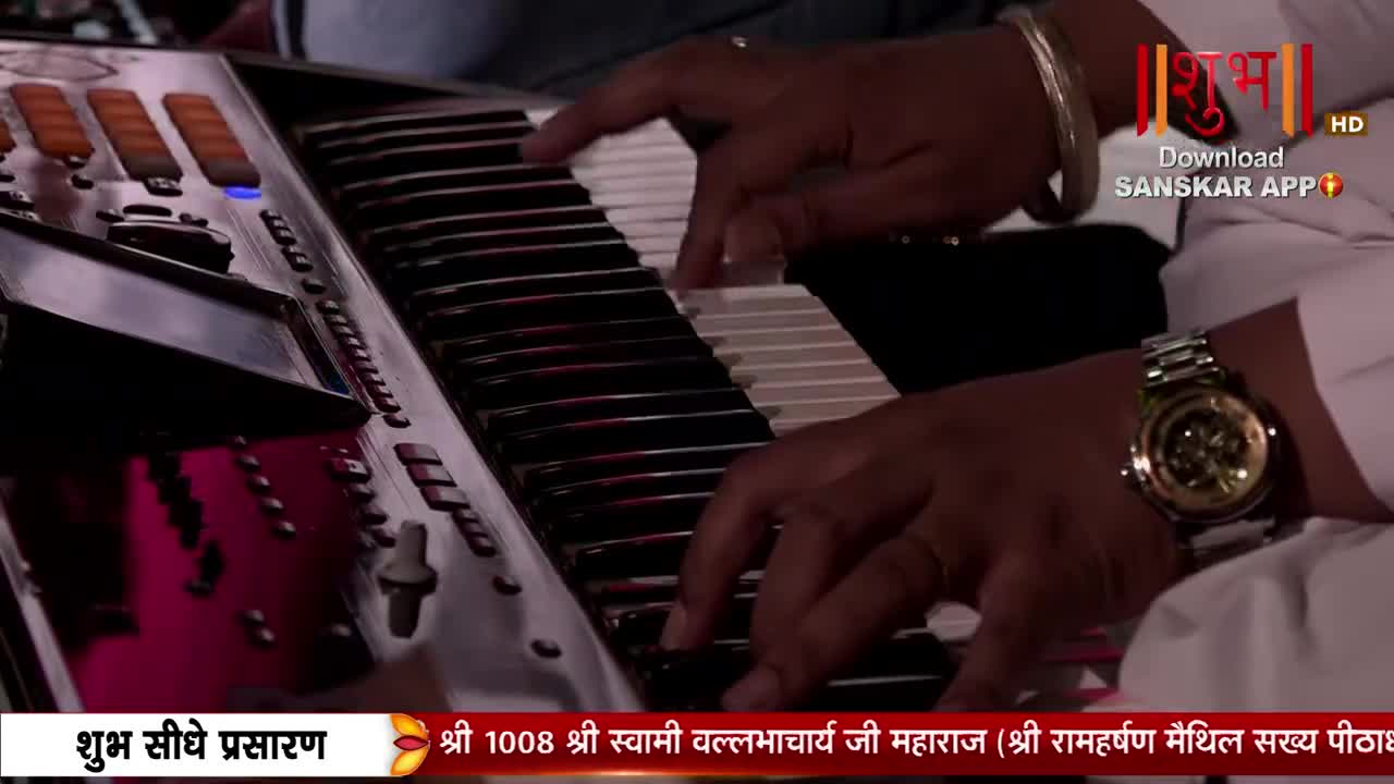 Fingers dance across the keys of a synthesizer, the musician's watch glinting under the lights. The Shubh TV logo and text at the bottom suggest a live broadcast from India.
