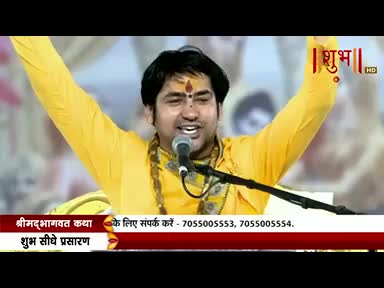 A man in a bright yellow shirt has both arms raised as he speaks into a microphone. The Shubh TV logo is visible in the top right corner, and the text below indicates a live broadcast from India.

