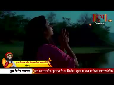 A woman in a pink top stands near water, her hands raised in prayer. The Shubh TV logo is visible, along with text in Hindi announcing a special broadcast.
