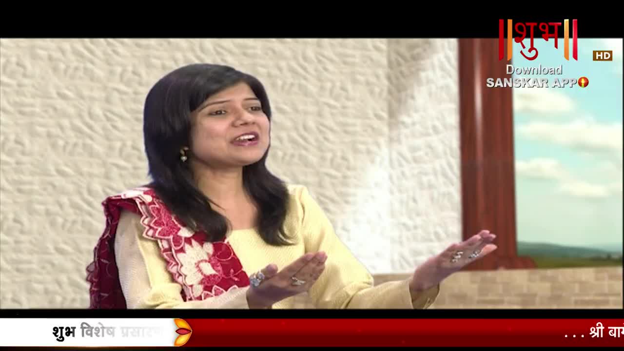 A woman in a yellow outfit with a red and white patterned shawl speaks animatedly, her hands gesturing outwards. The Shubh TV logo appears in the upper right corner.