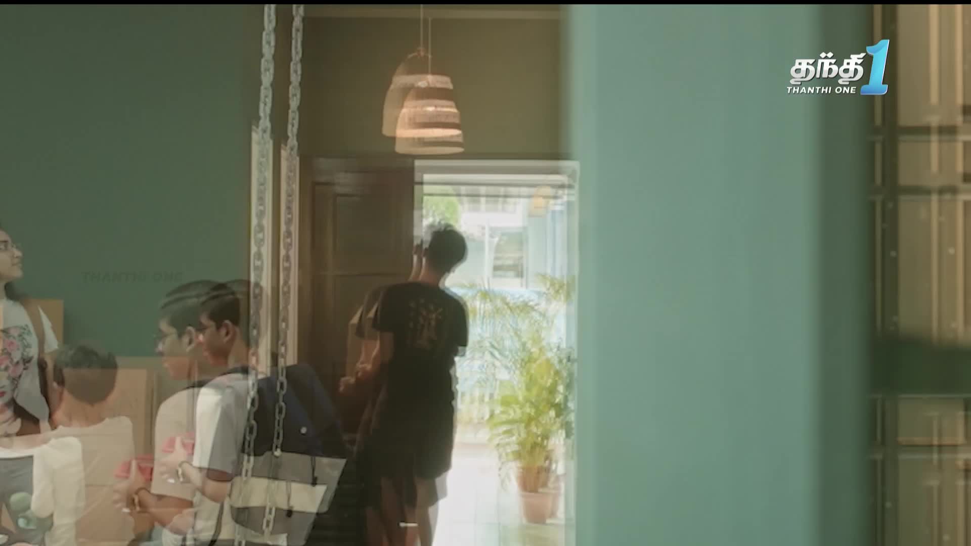 Inside, a young man in a black t-shirt is walking toward the doorway, his back to the camera. The Thanthi One logo is visible in the top right corner.
