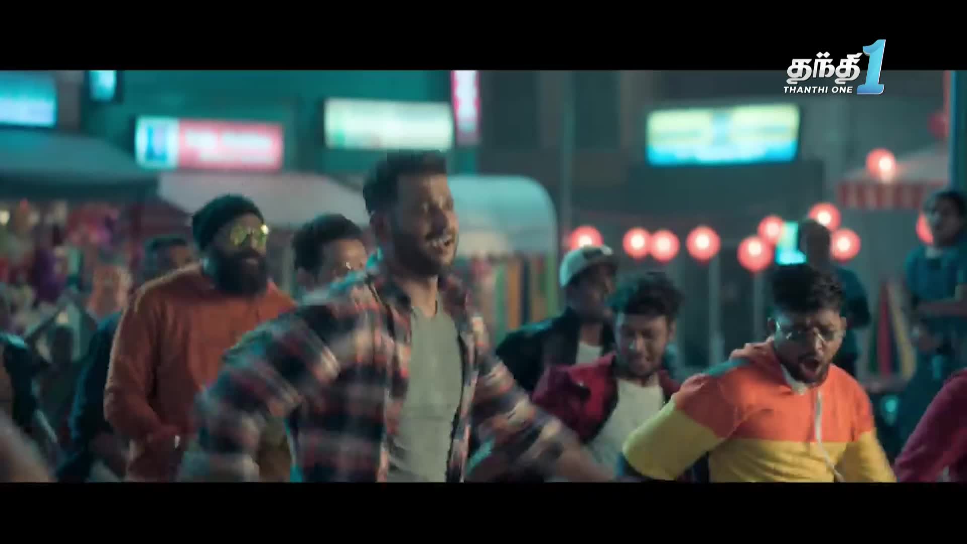 A group of men, some in casual clothes, are dancing and moving forward. The Thanthi One logo is visible in the top right corner.
