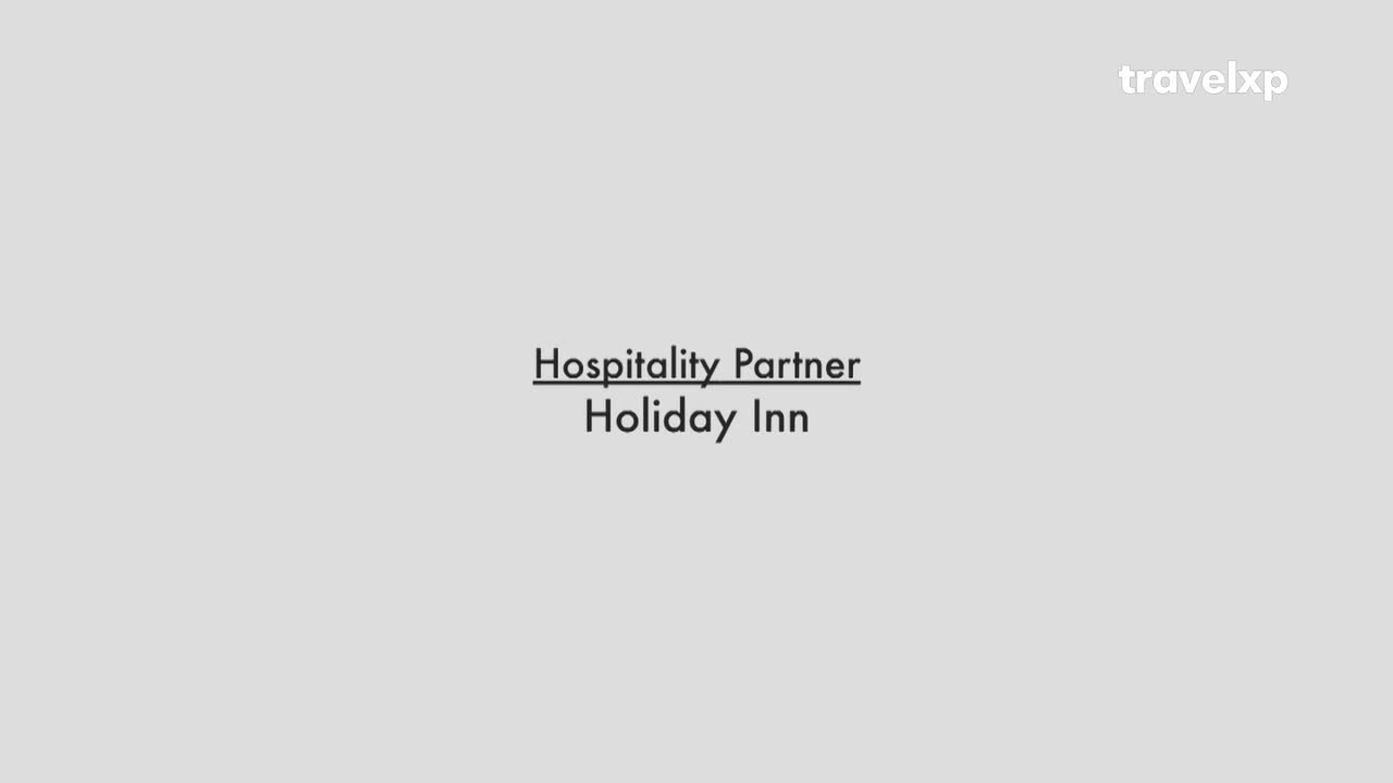 The Travelxp logo sits in the upper right corner. Below that, the text "Hospitality Partner Holiday Inn" is centered on a gray background.
