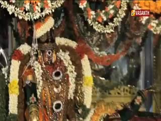 A decorated idol, draped in garlands, is the focal point. The Vasanth TV logo is visible in the corner, indicating a broadcast from India.
