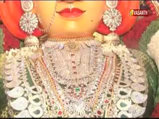 A large, ornate statue of a deity, likely from India, is on display. The Vasanth TV logo is visible in the corner, indicating a broadcast of the religious ceremony.
