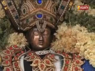 A decorated statue is on display, framed by garlands of flowers. The Vasanth TV logo is in the corner, suggesting this is a broadcast from India.
