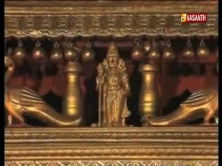 A gold statue of a deity stands between two ornate, golden sculptures. The Vasanth TV logo is visible in the corner, broadcasting from India.
