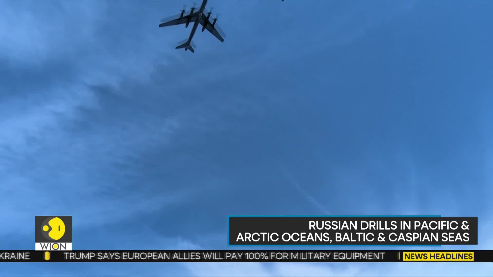Above, a large aircraft is silhouetted against a cloudy blue sky. The WION logo and a news headline about Russian drills are visible at the bottom.
