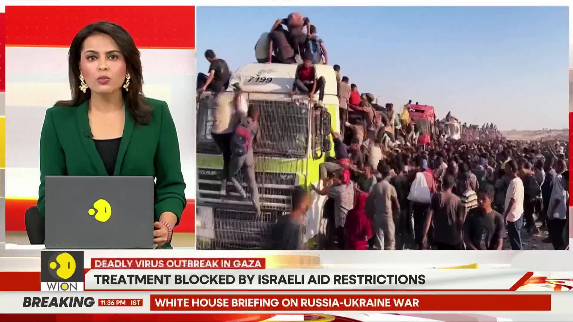 People are climbing onto and clinging to a truck, while a massive crowd surrounds it.  The scene is being reported on WION, with the headline referencing a Gaza virus outbreak.
