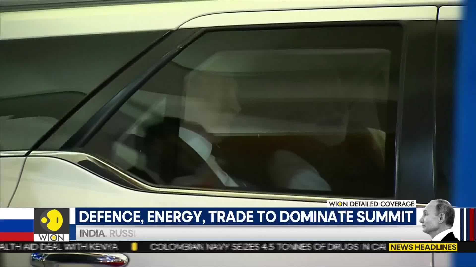 A white car is parked, its windows reflecting the surroundings. Through the tinted glass, a figure in a white shirt is visible, likely being covered by WION.
