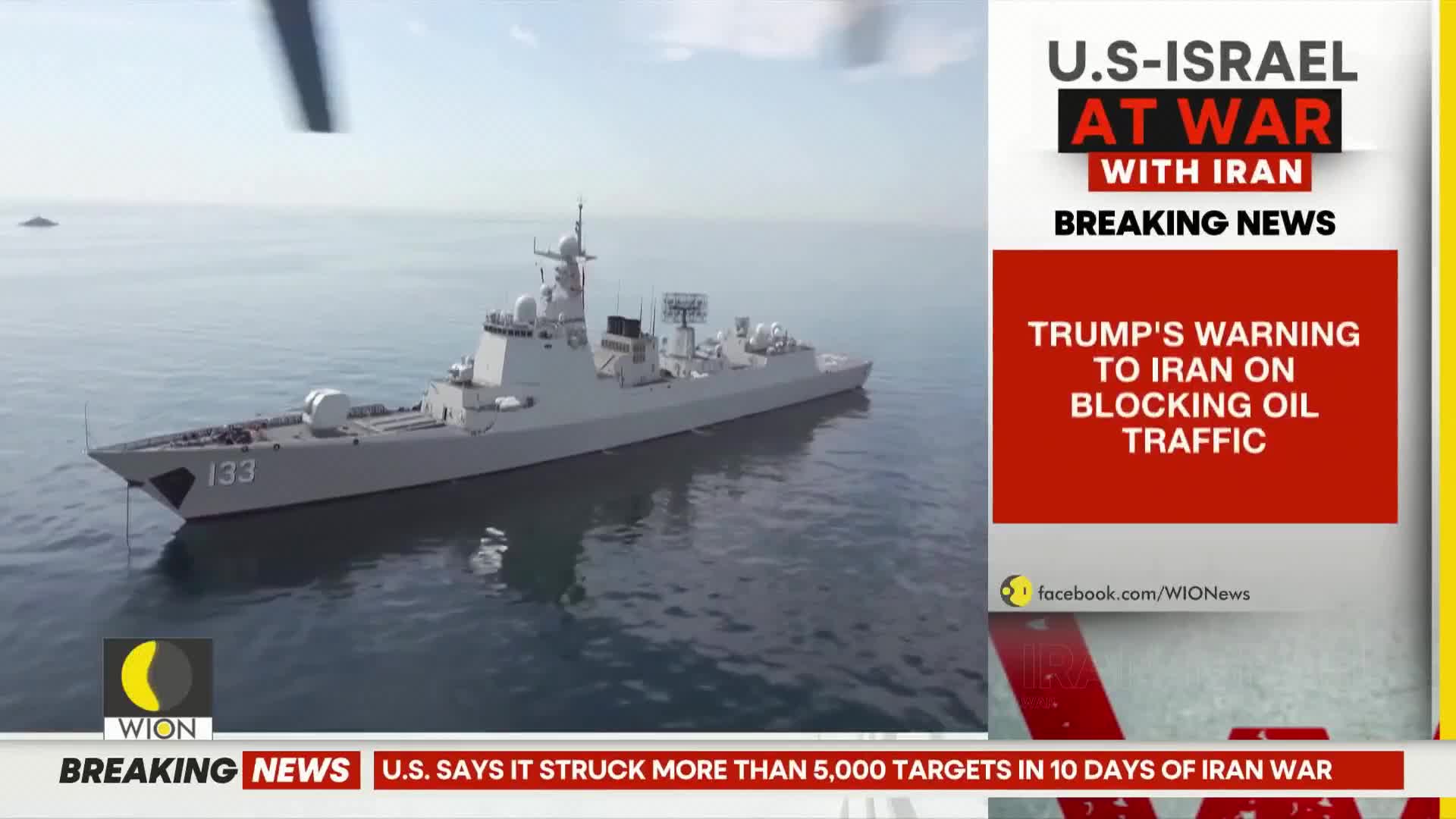A large gray warship, hull number 133, glides through calm water. A news ticker from WION scrolls below, reporting on U.S.-Israel tensions with Iran.